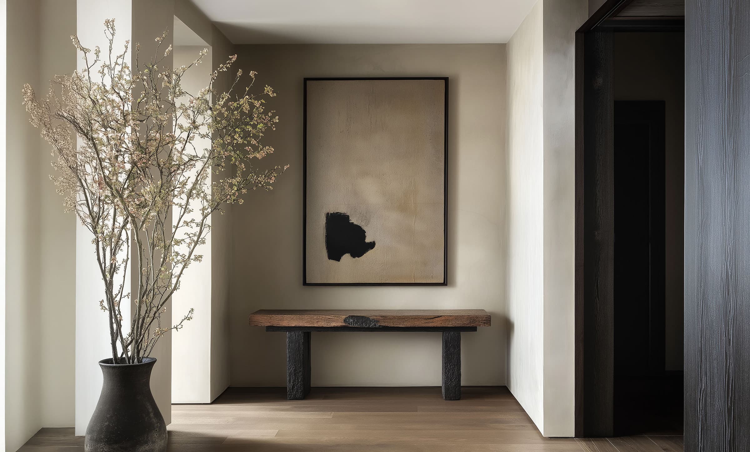 A serene minimal room with art on the wall
