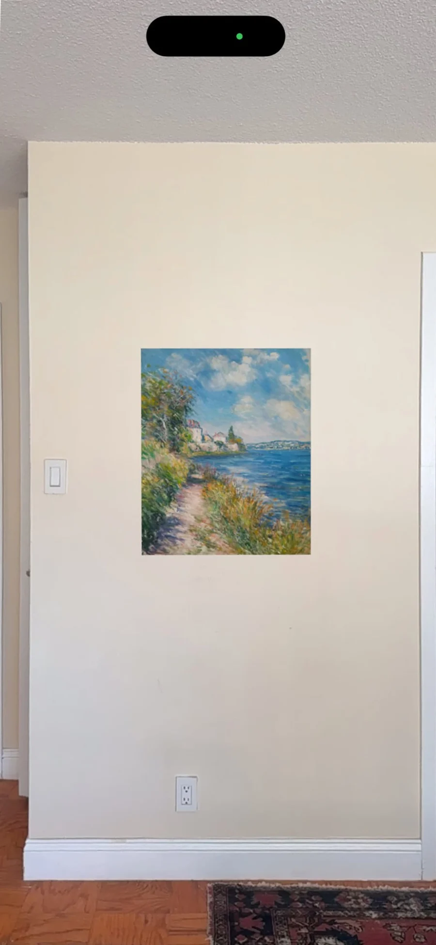 Cliffside Light Over Water hanging on a real wall at its real size, seen through a phone camera