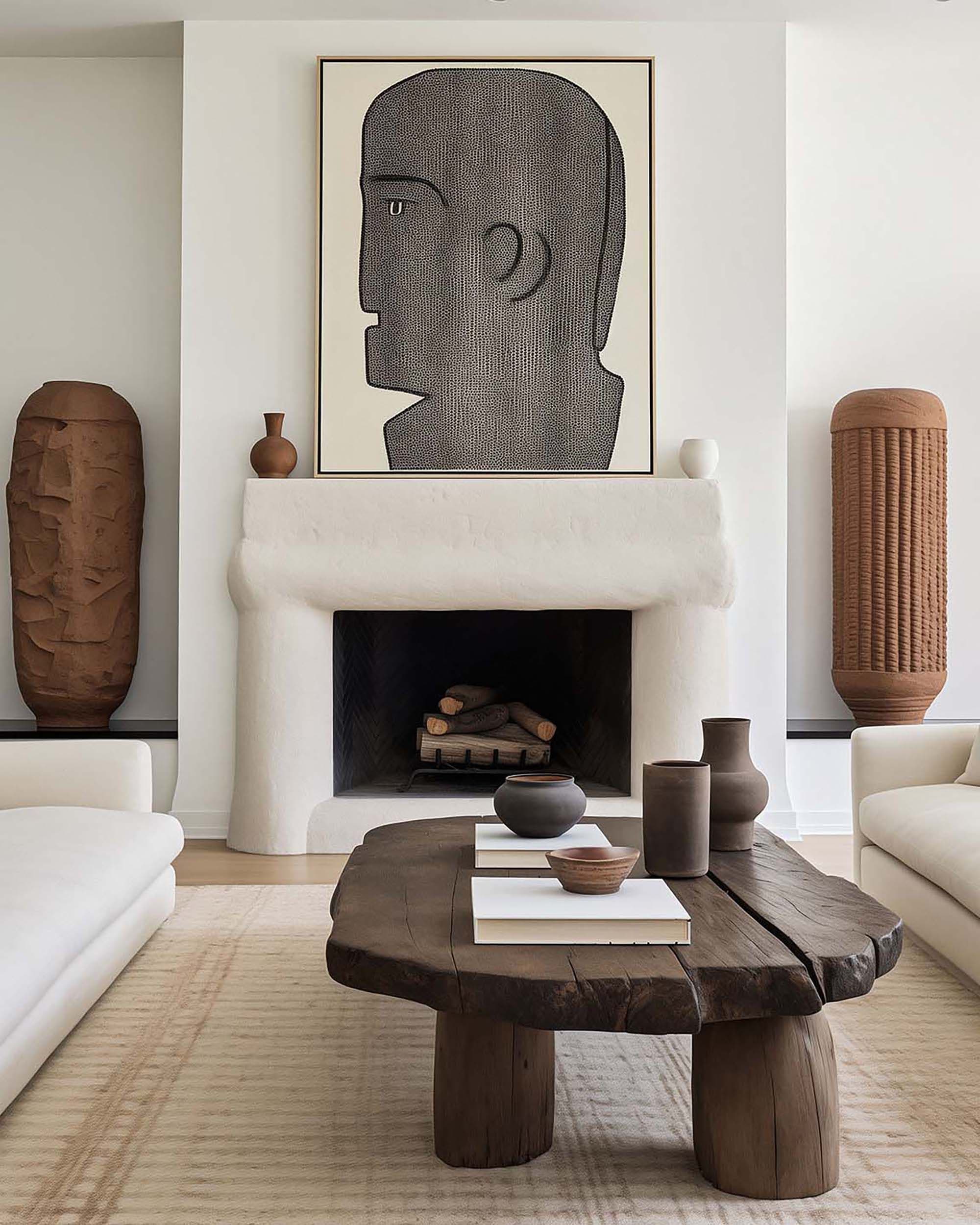 Living room with a large framed artwork above a white stucco fireplace, flanked by sculptural vases and a wood coffee table.