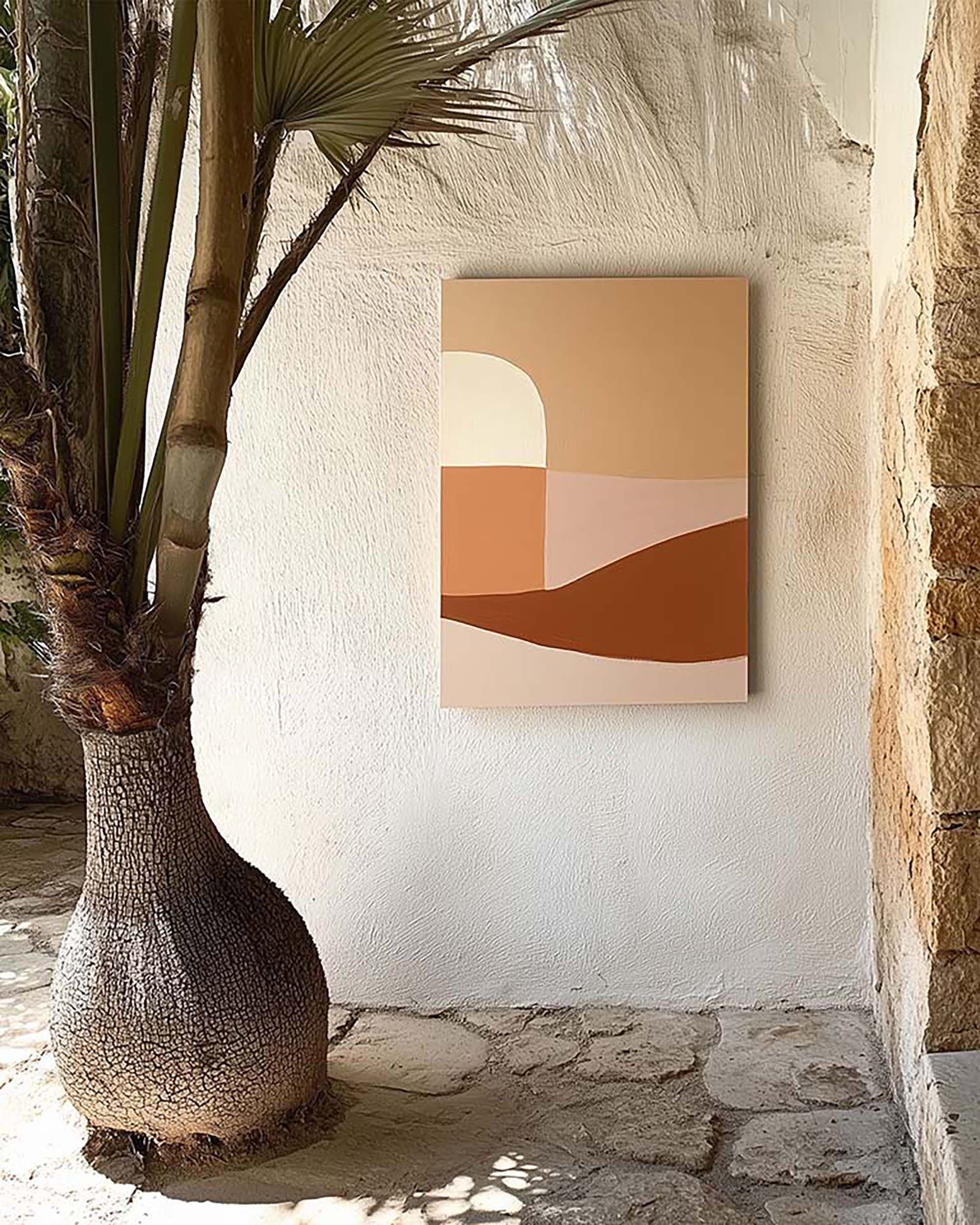 Outdoor patio wall with a customizable frame on textured white plaster, beside a large potted palm on a stone floor.