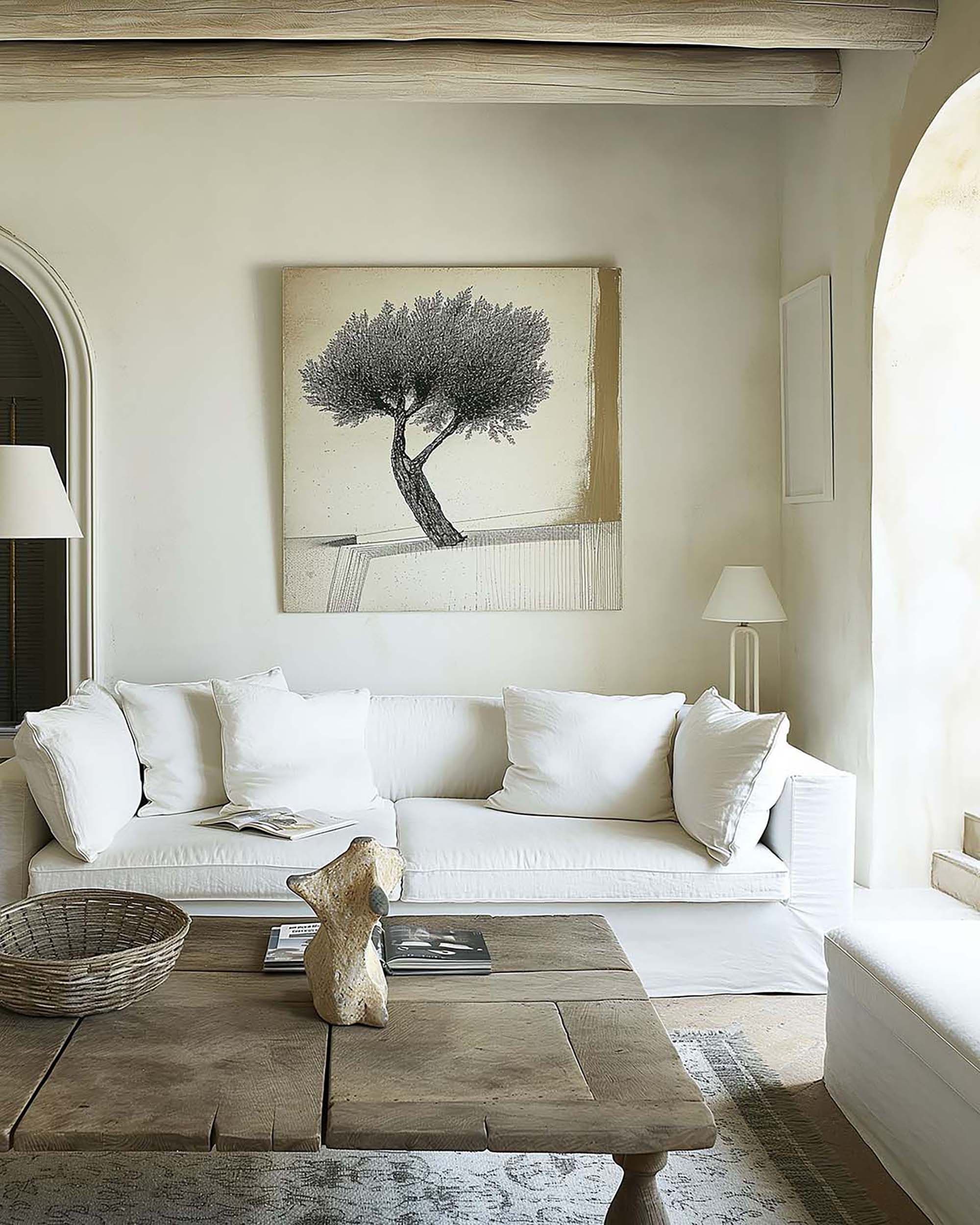 Neutral living room with a large wall frame above a white sofa, plus a rustic wood coffee table and table lamp.